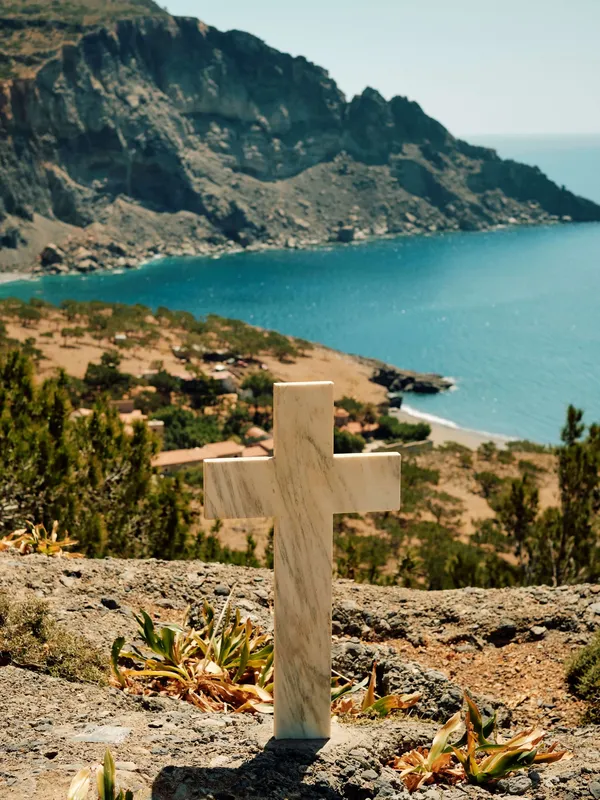 A cross overlooking the sea in Crete Greece Slow Cyclist