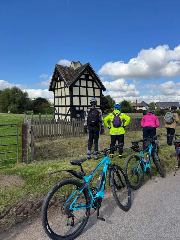 Bikes and cyclists enjoying black and white house, herefordshire, UK