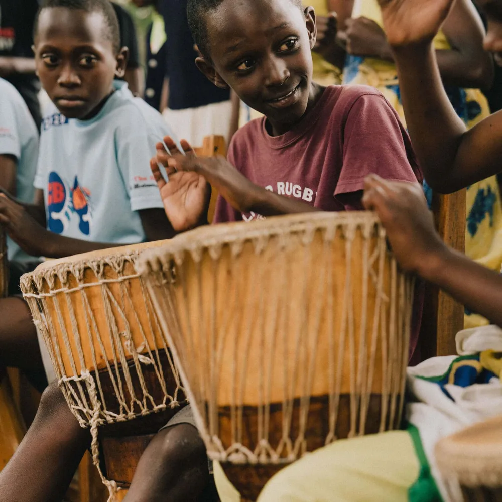 Children okaying the drums at the Kinamba Project in Kigali, Rwanda
