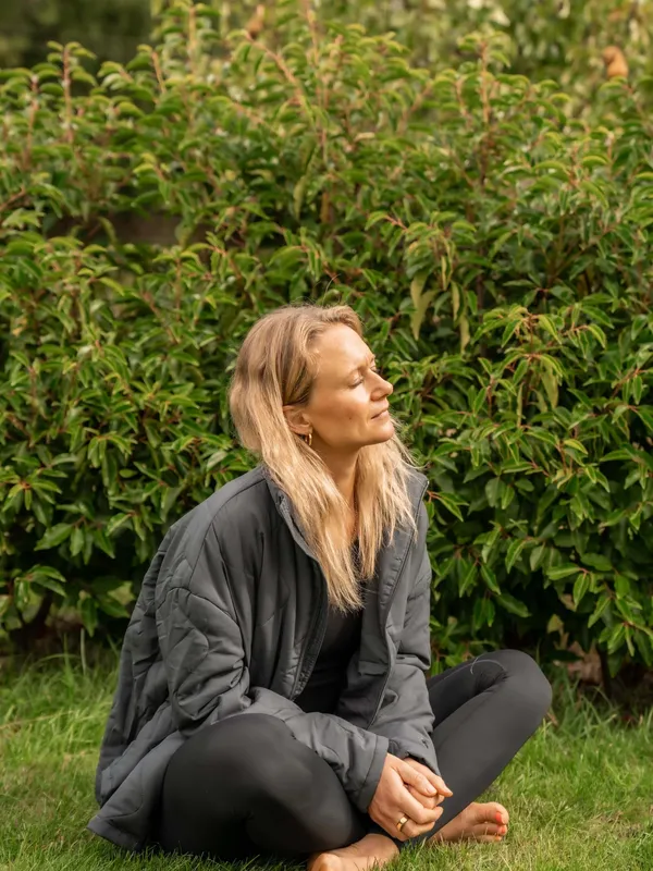 Chloe from Chloe's Pilates meditating in her garden