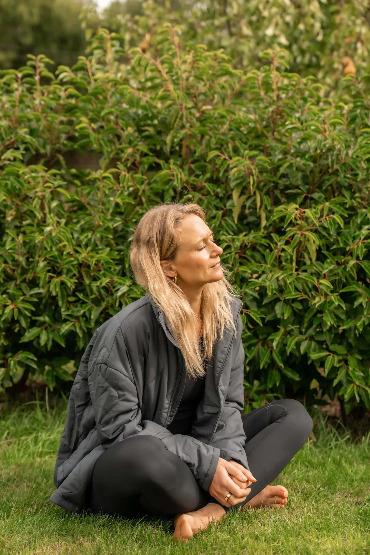 Chloe from Chloe's Pilates meditating in her garden