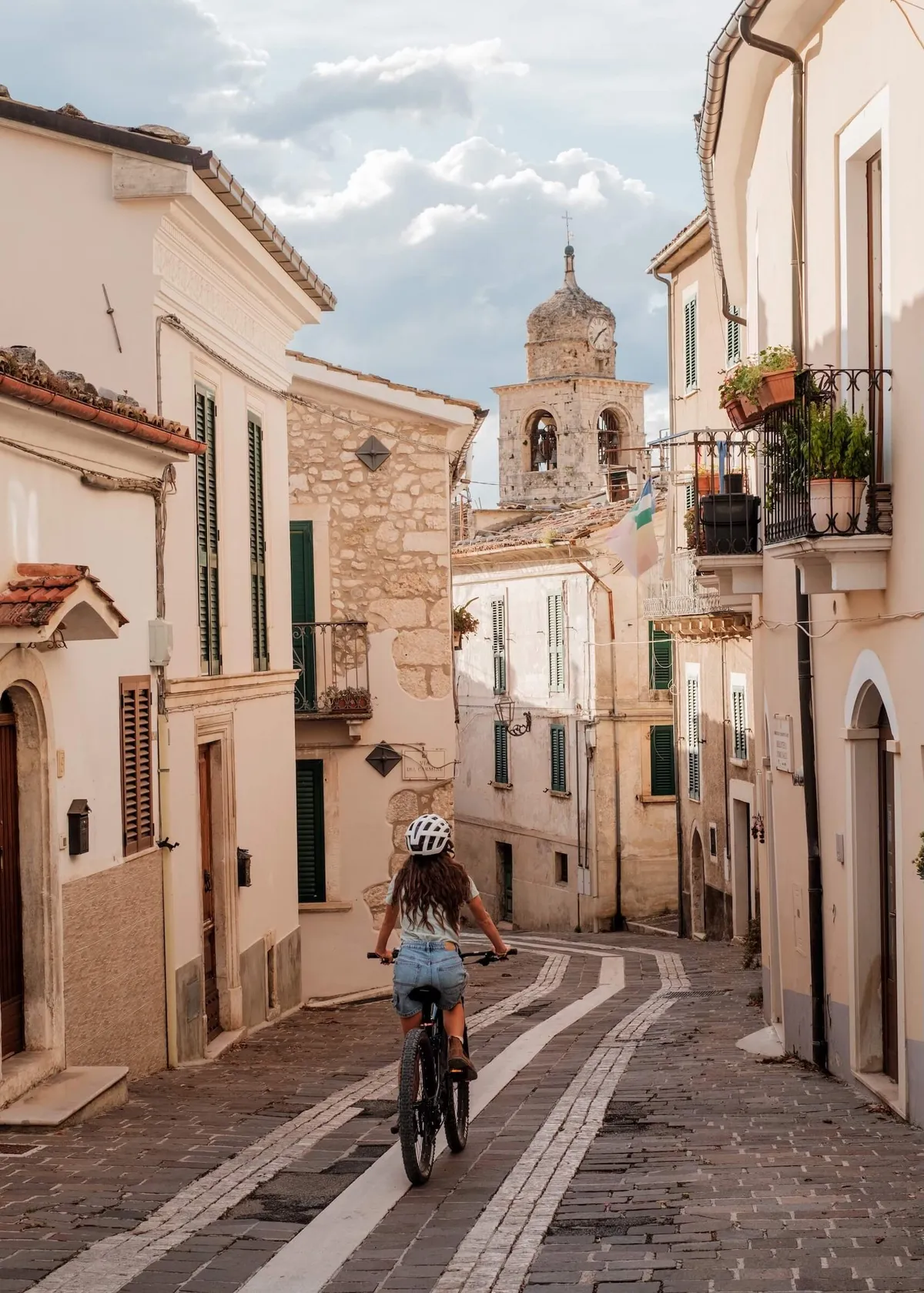 A Slow Cyclist guide cycling through the village of Caramanico in Abruzzo