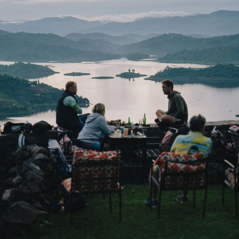 Slow Cyclist guests enjoying a drink overlooking Lake Ruhondo in Rwanda