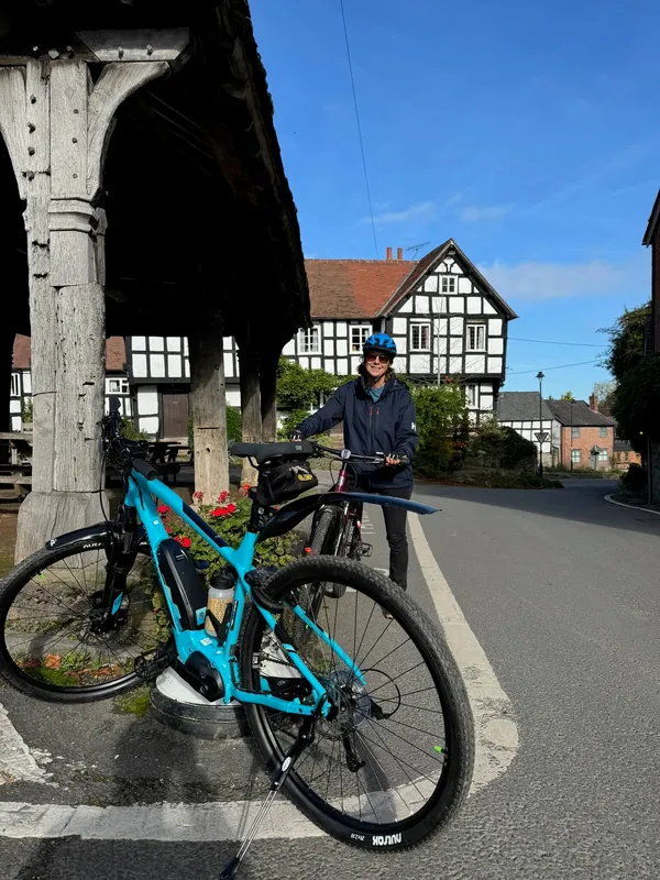 Electric bike in front of village square black and white villages, herefordshire,UK