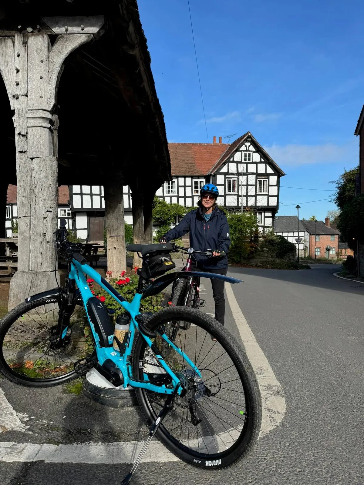 Electric bike in front of village square black and white villages, herefordshire,UK