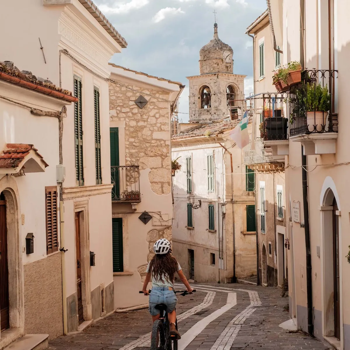 Female cyclist riding on street around Caramanico, Abruzzo , Italy