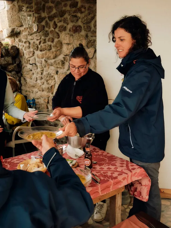 Guide Julia offering soup to guests, coa valley, portugal