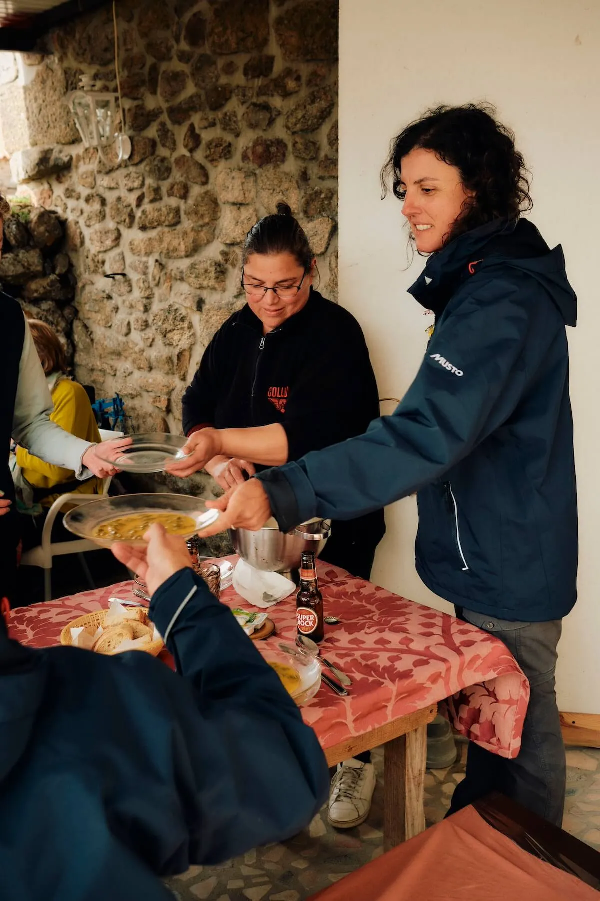 Guide Julia offering soup to guests, coa valley, portugal