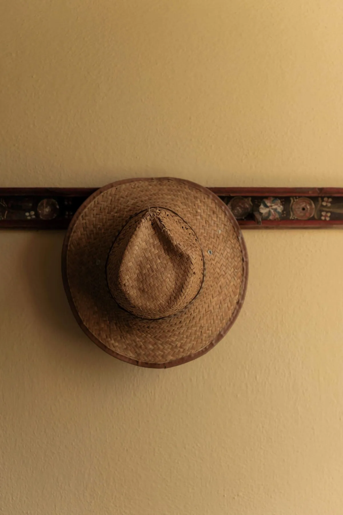 A hat hanging on the wall in Copsa Mare Guesthouses, where Slow Cyclists stay in Transylvania