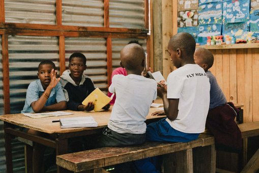 Children sit around a table learning at the Kula Malaika Foundation, South Africa's Karoo