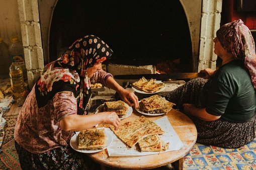 Two local women cooking Gozleme for Slow Cyclists in Turkey's Taurus Mountains.