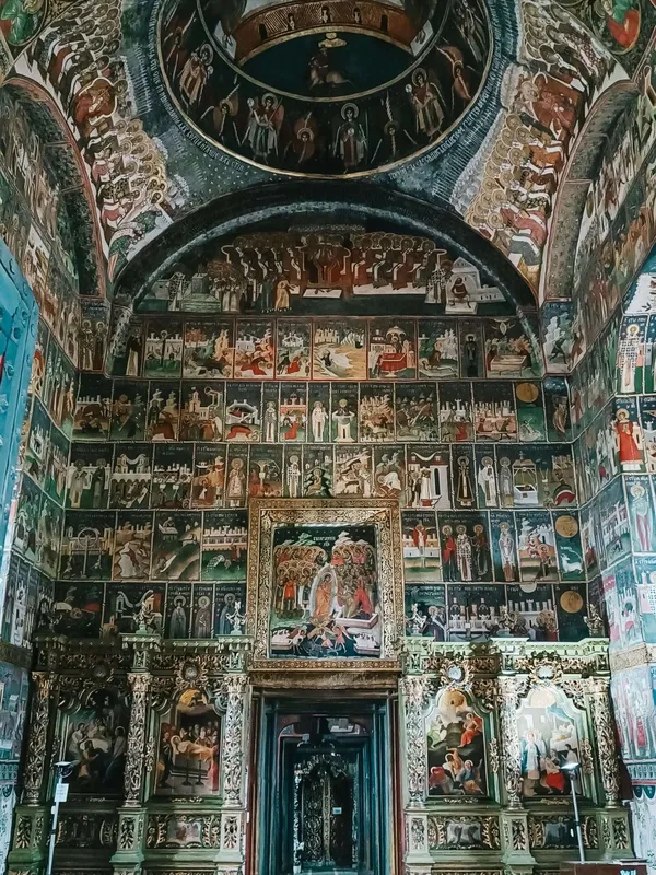 The interior of a painted church in Bucovina, as seen on Romania's Via Transilvanica by Slow Cyclists