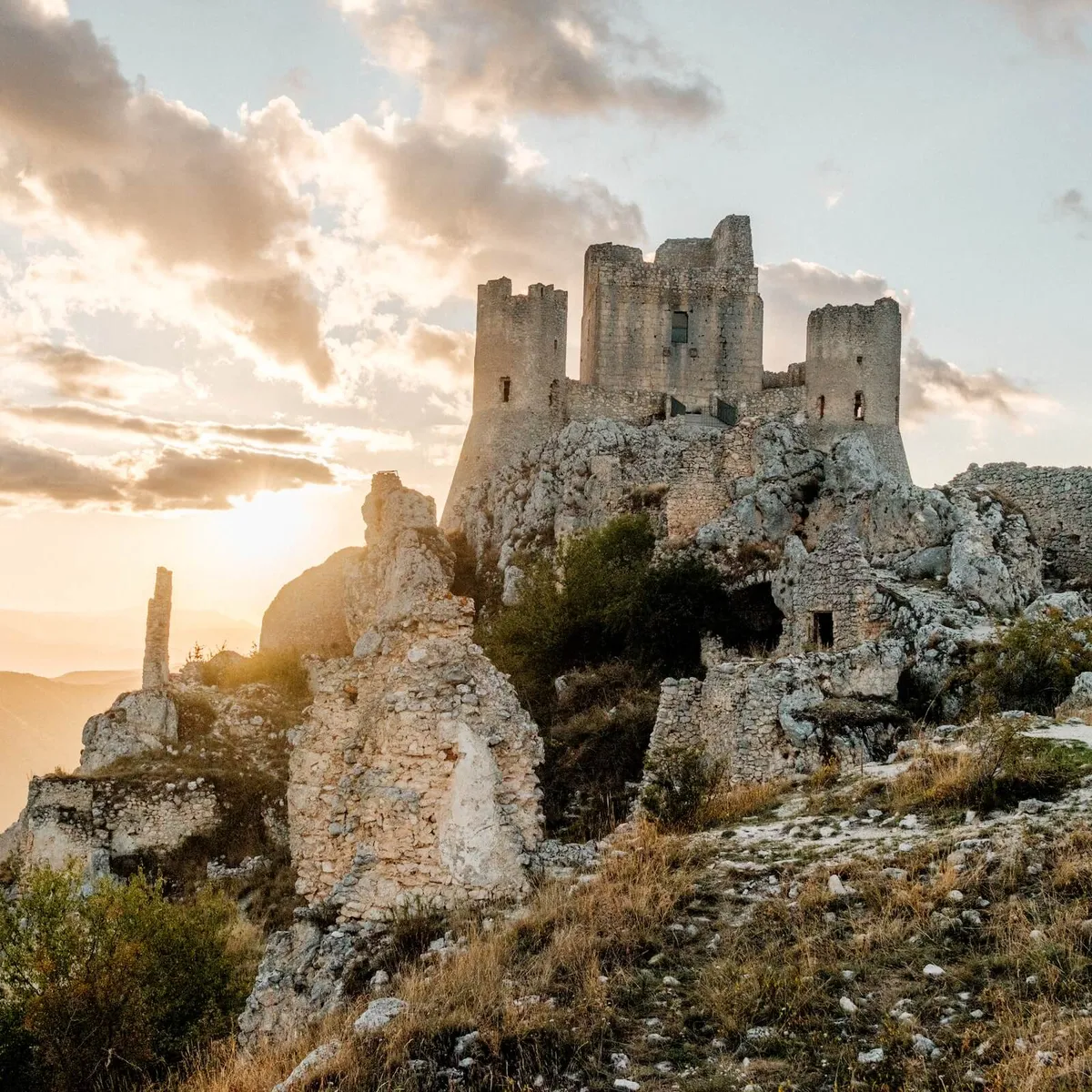 Ruins of Castel of Rocca Calascio on the hillside at sunset, Abruzzo, Italy