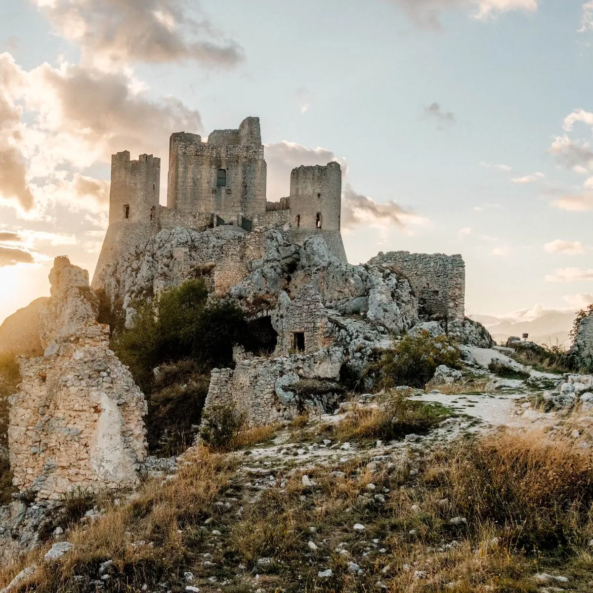 Ruins of Castel of Rocca Calascio on the hillside at sunset, Abruzzo, Italy