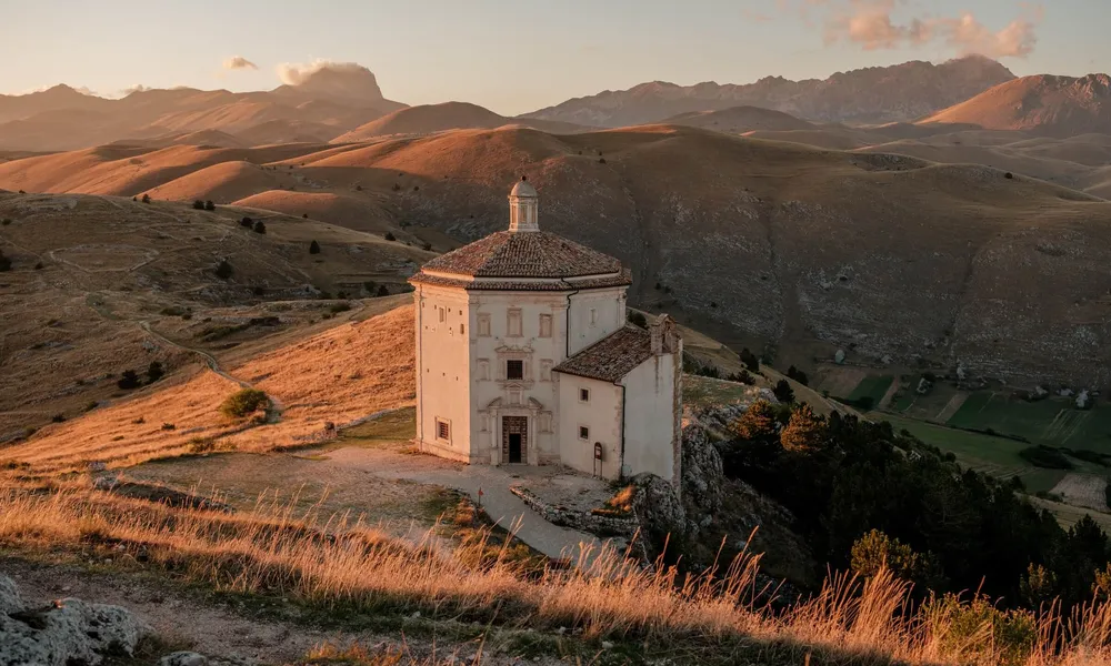 Octagonal Santa Maria della Pieta church at sunset in Gran Sasso National Park