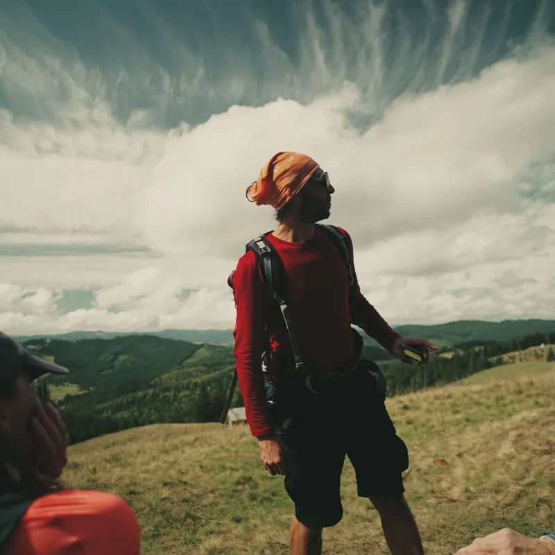 A Wild Lines guide speaking to two guests in the rolling hills of Bucovina, Romania,