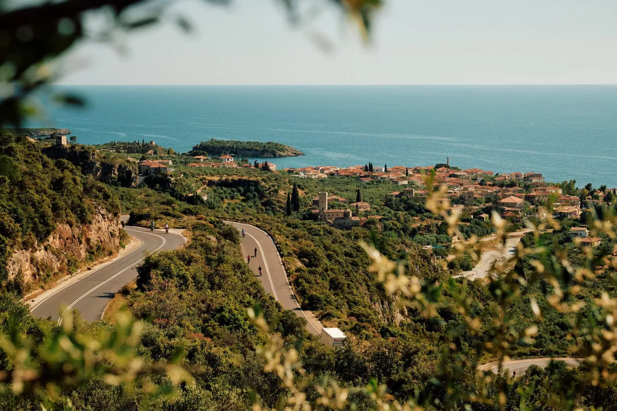 A group of Slow Cyclists winding down the road on their e-bikes in the Mani, Greece's Peloponnese
