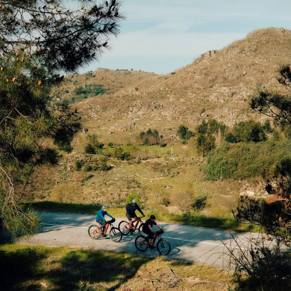A group of Slow Cyclists cycling through the rugged landscapes of Portugal's Coa Valley