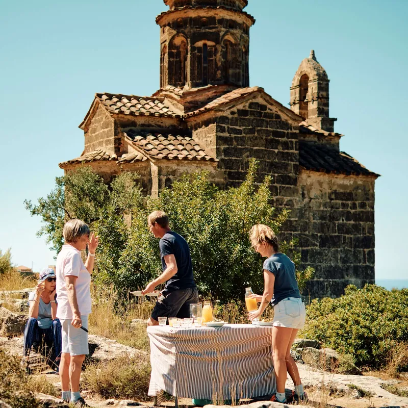 Slow-Cyclists-taking-a-break-by-church-Mani-Greece