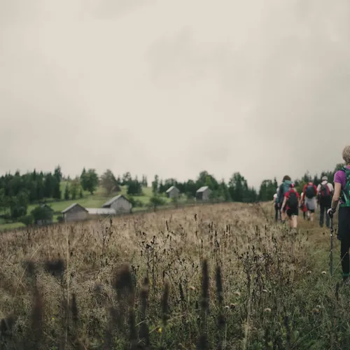 Slow-Cyclists-walking-among-traditional-farm-buildings-in-Bucovina-Romania