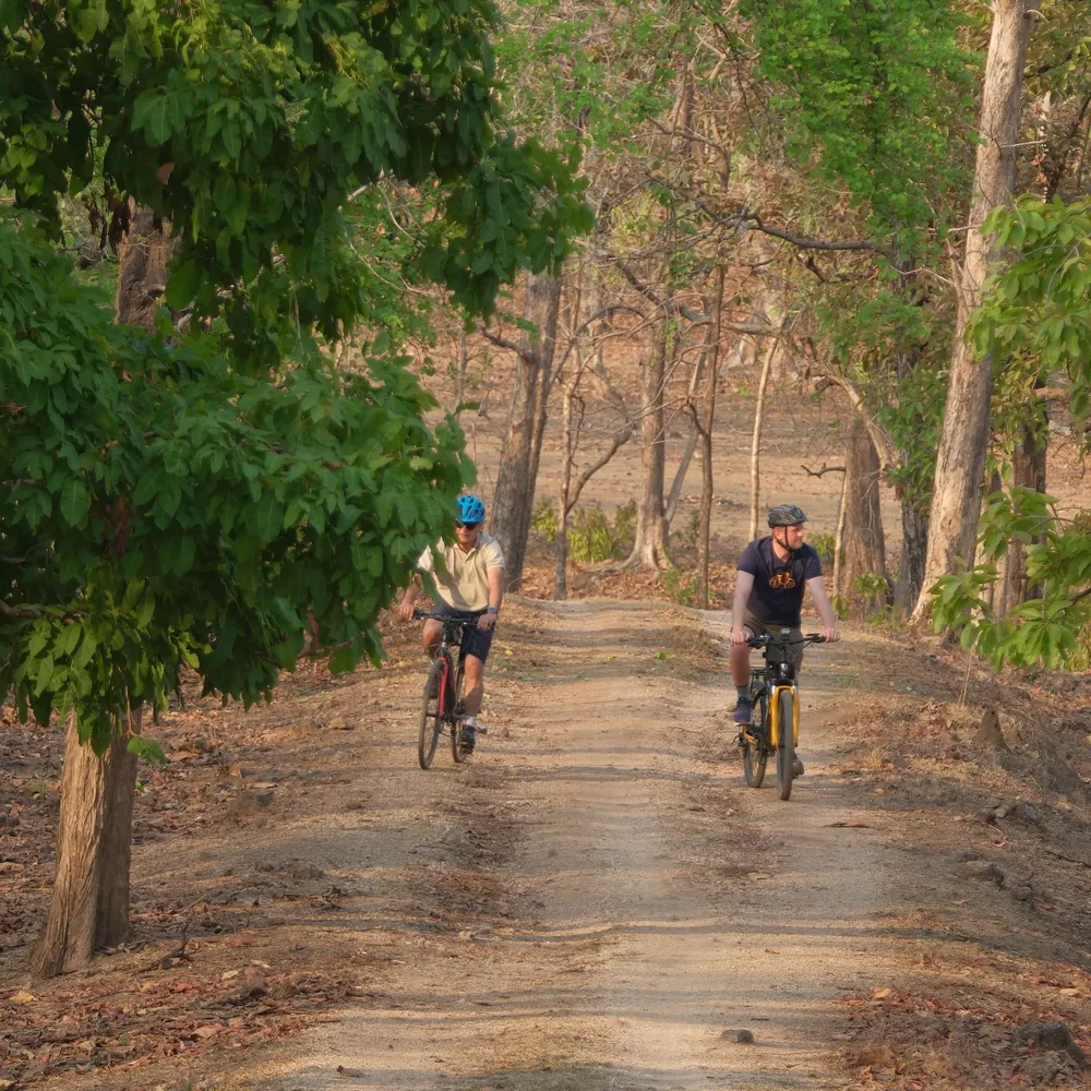 Two Slow Cyclists riding in a national park in India