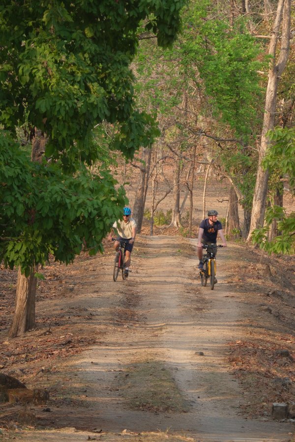 Two Slow Cyclists riding in a national park in India