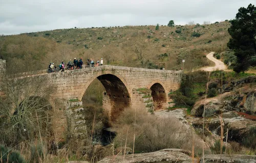 Slow Cyclist guests on a stone bridge in Portugal's Coa Valley