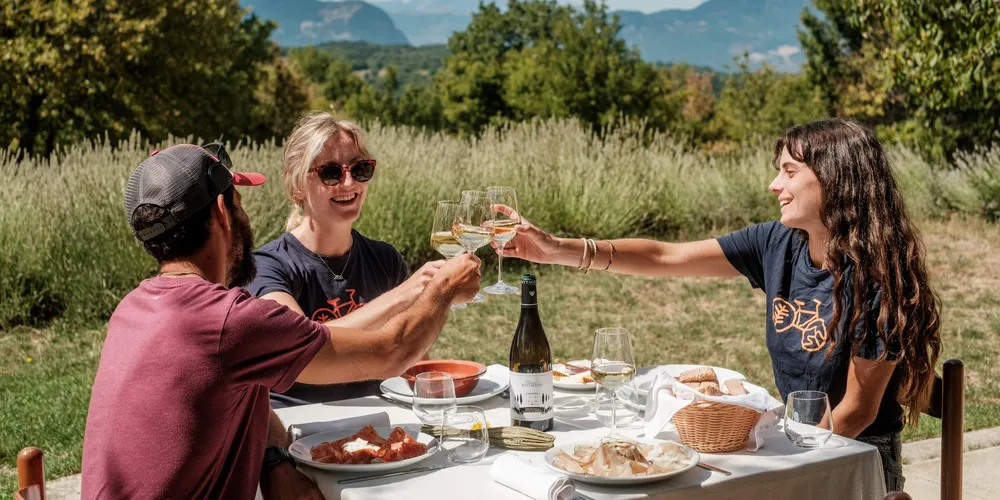 Slow cyclists enjoying picnic lunch and wine at Terrae Eremis, Abruzzo, Italy