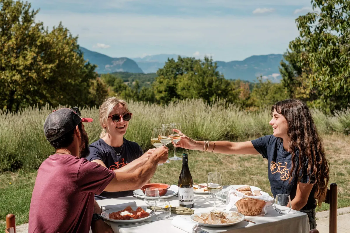 Slow cyclists enjoying picnic lunch and wine at Terrae Eremis, Abruzzo, Italy
