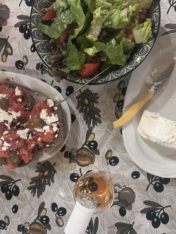 Table of dishes in crete and wine pouring