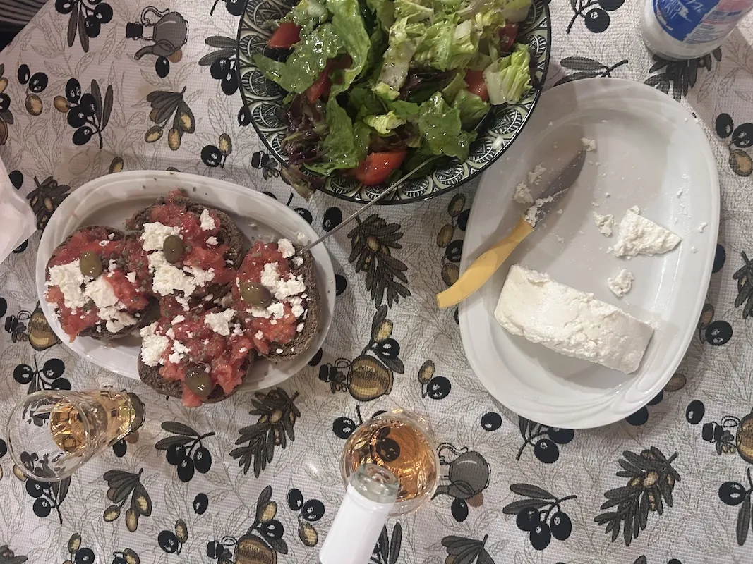 Table of dishes in crete and wine pouring