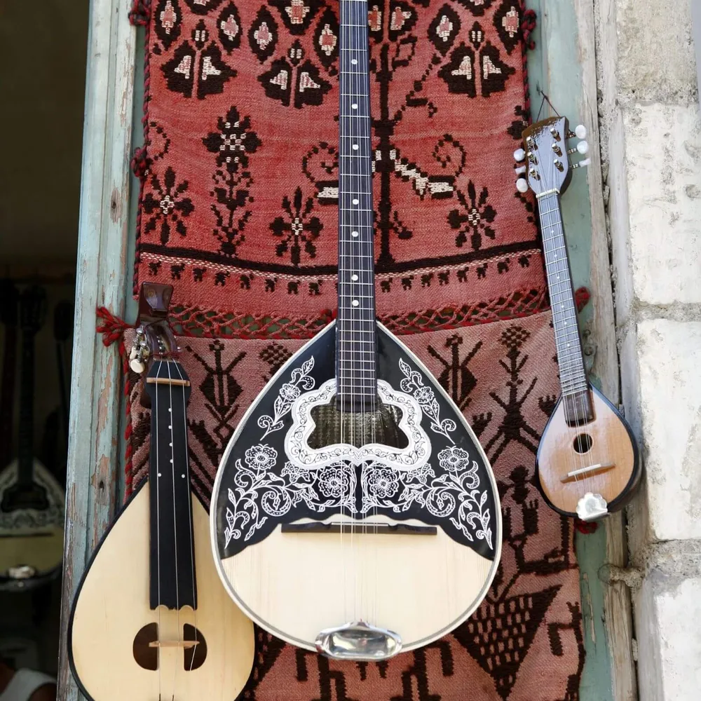 Traditional instruments of Crete, including the lyra, often heard on a Slow Cyclist journey