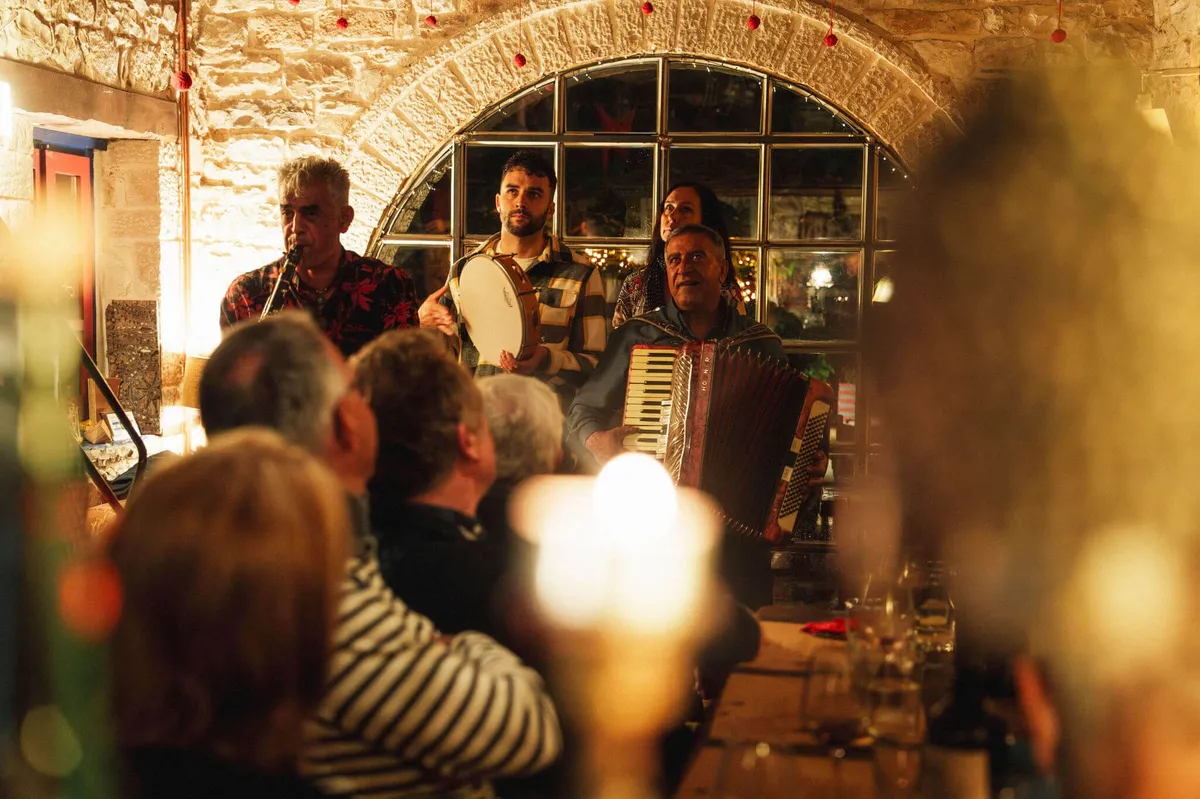 Traditional musicians playing Greek music for Slow Cyclists in Zagori.