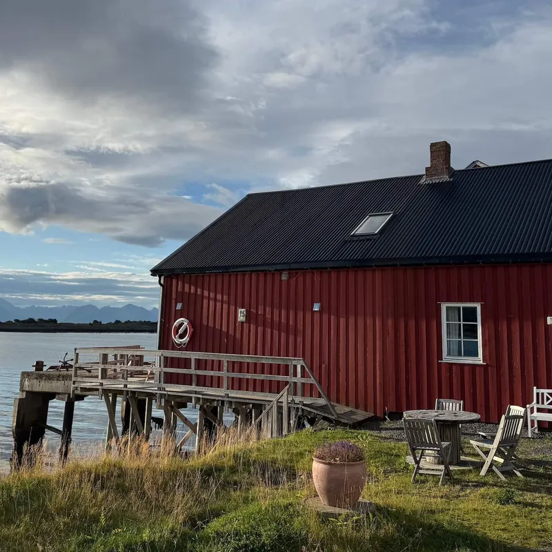 Traditional red timber house on fjord, Vesteralen Islands, Norway