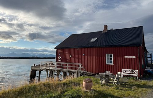 Traditional red timber house on fjord, Vesteralen Islands, Norway