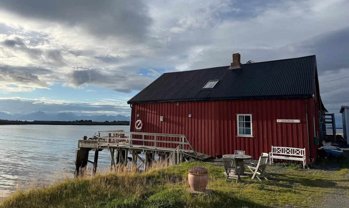 Traditional red timber house on fjord, Vesteralen Islands, Norway