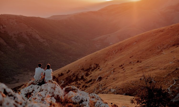Two Slow Cyclists watching the sunset at Rocca Calascio