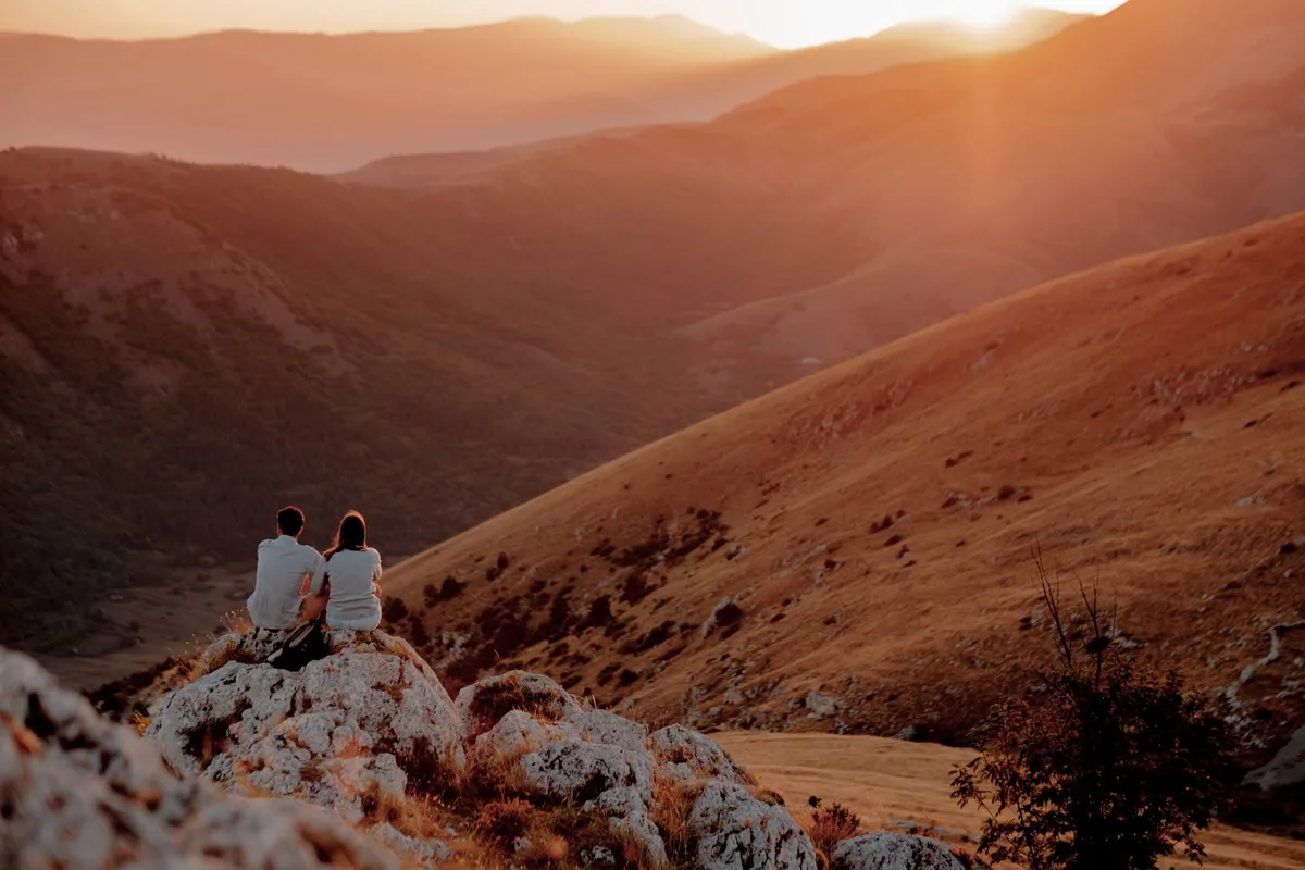 Two Slow Cyclists watching the sunset at Rocca Calascio