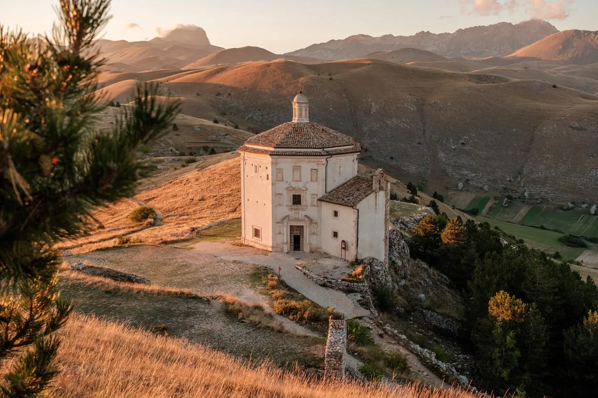 View of Church of Santa Maria della Pieta at dusk and surrounding countryside, Abruzzo, Italy