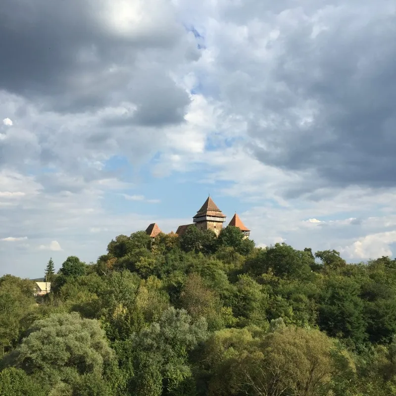 Two Slow Cyclists enjoying a picnic under a tree by a Saxon house in Romania