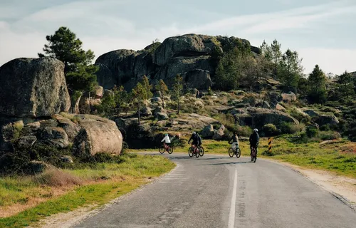 cyclist on road in front of rocky outcrop, Coa Valley, Portugal