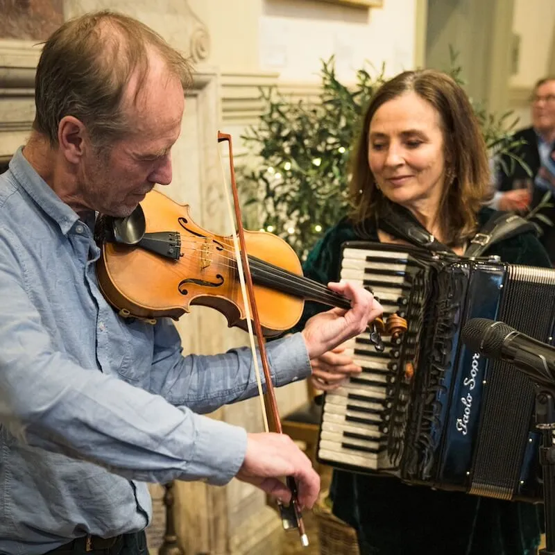giles and melissa, larkspur playing their instruments at 10 year party