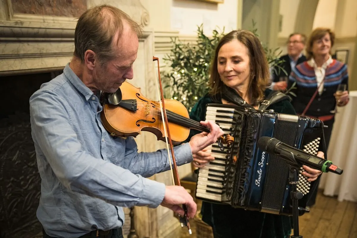 giles and melissa, larkspur playing their instruments at 10 year party