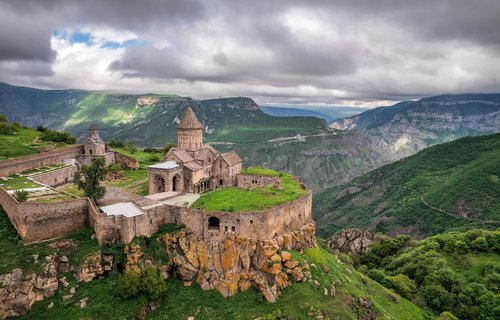 Church and village on hill over mountains, Armenian Highlands