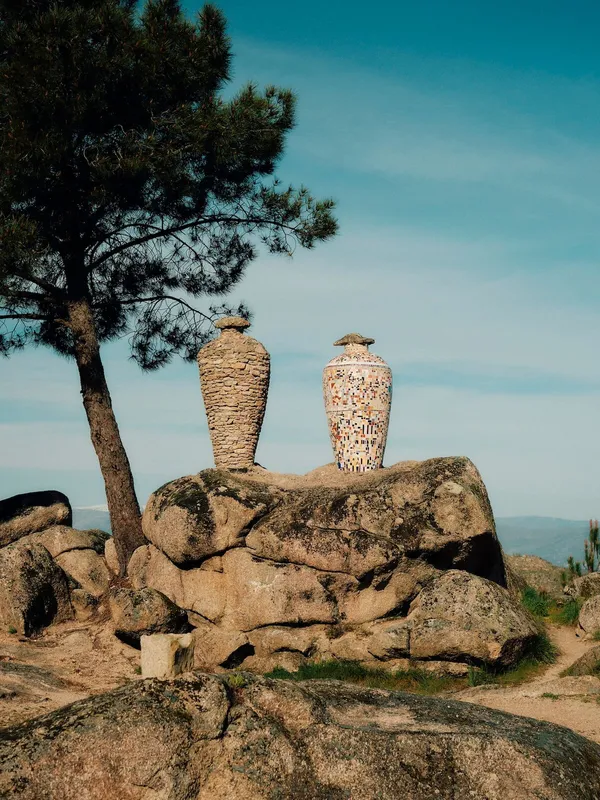 Arch showing village in côa valley, portugal with cyclists.