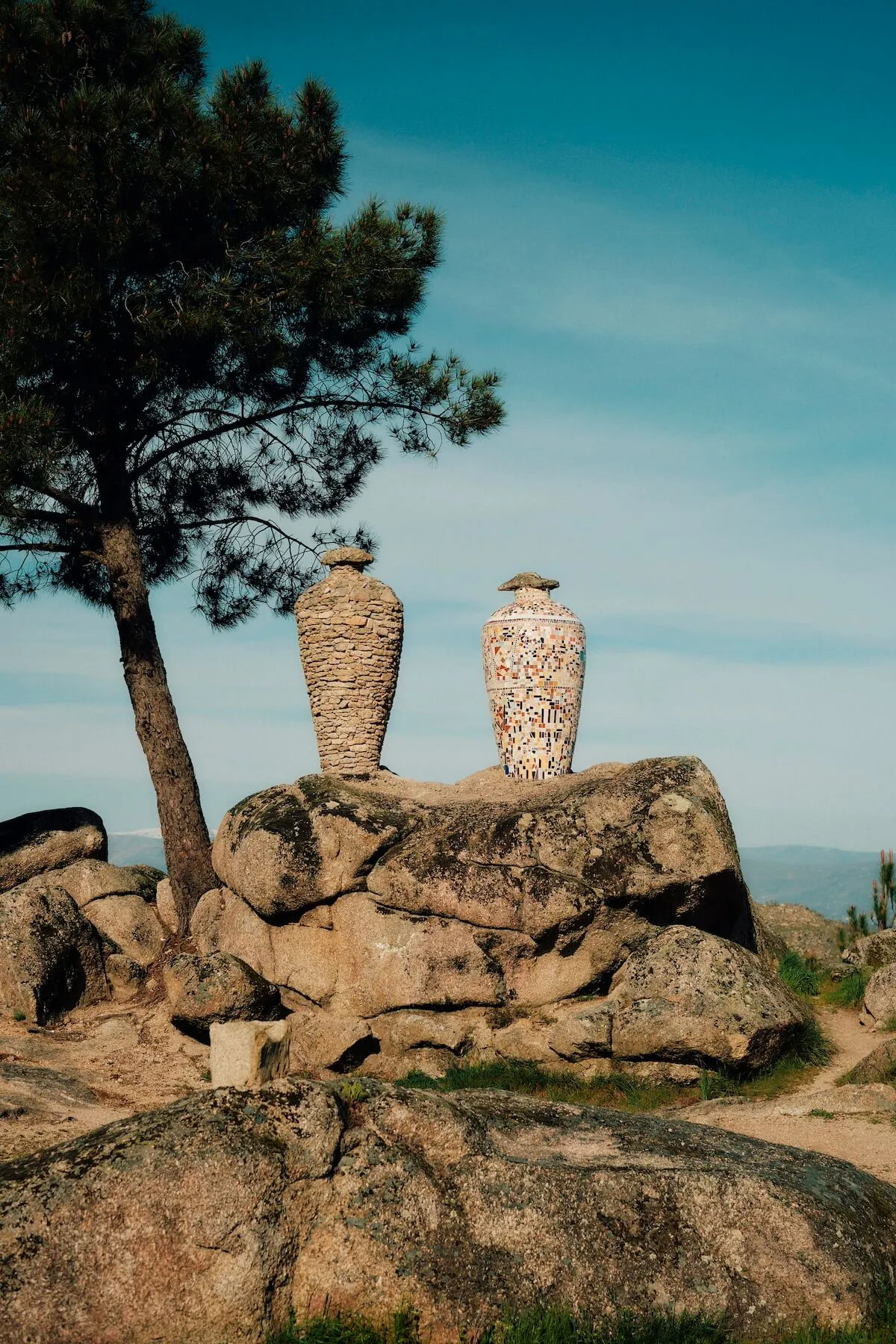 Arch showing village in côa valley, portugal with cyclists.